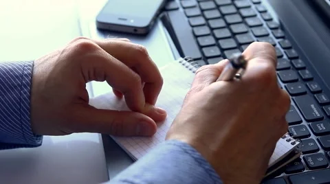 Man writing in his notpead Stock Footage 46974712