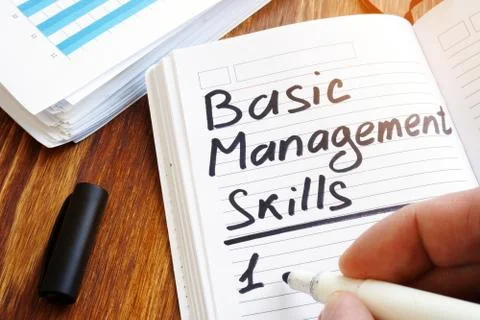 Man is writing list of Basic management skills. Stock Photos