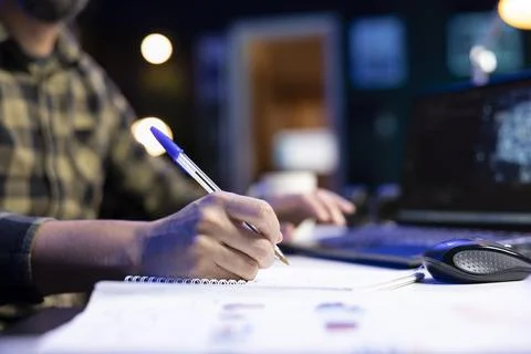 Man writing machine code on notebook 스톡 사진