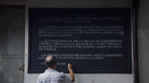 Man writing mandarin on chalkboard Video stock 78771347