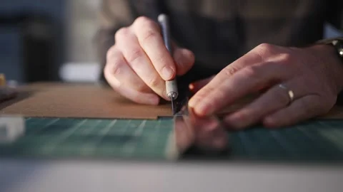 A man is writing with a marker on a green surface Video stock 302442693