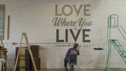 Man writing message on wall at street Stock Footage 87805628