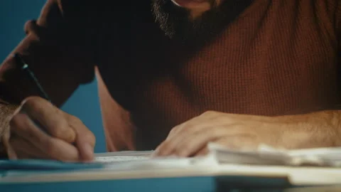 Man writing musical notes at a desk Stock Footage 135388413