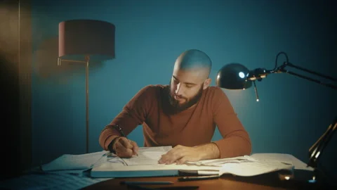 Man writing musical notes at a desk Stock Footage 135388439