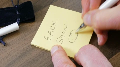 Man writing note ‘Back soon’ with ballpoint pen. Stock Footage 107831351