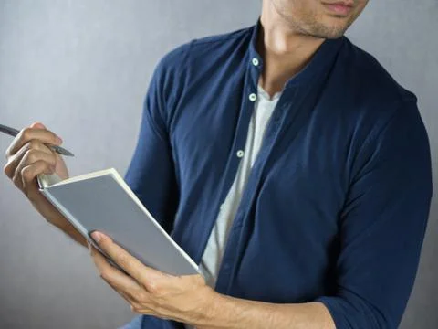 Man writing on note book close up Stock Photos