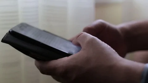 Man Writing a Note or Texting on His Phone in Natural Light Stock Footage 76356254