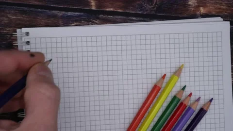 A man writing in a notebook with a colored pencil Stock Footage 141788176