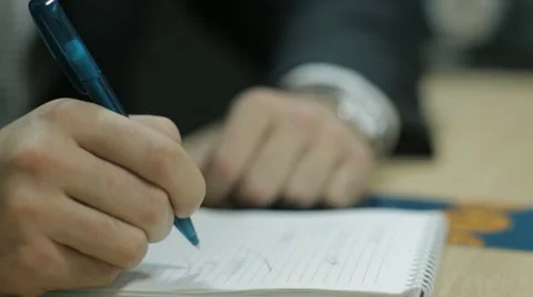 Man writing in notebook Stock Footage