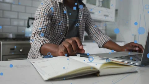 Man writing notebook, putting pen down, using trackpad, typing on laptop, blue Stock Footage 333925489