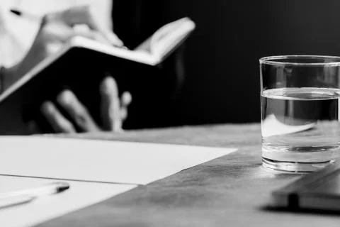 The man is writing in a notebook in a workplace. The concept of a work and ed Stock Photos