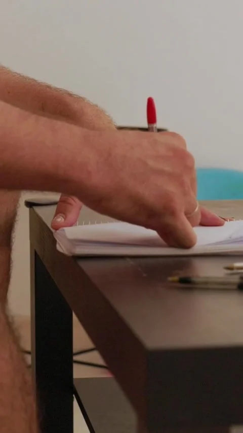 Man writing on notepad on a coffee table Stock Footage 327862524