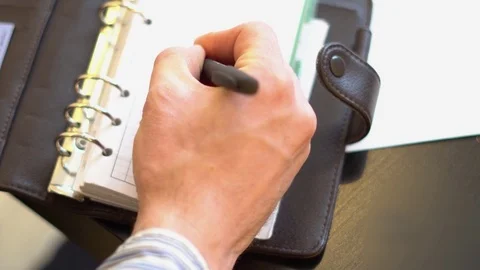 Man writing in Notepad Stock Footage 82815089