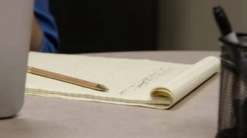 Man Writing on Notepad Stock Footage 85637696