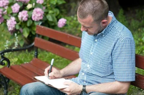 Man writing in notepad Stock Photos