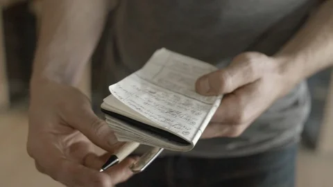 Man writing notes on a diary Stock Footage 87613465