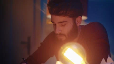 Man writing notes at his desk Stock Footage 135384102