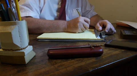 Man writing notes in his office desk Stock Footage 56742279