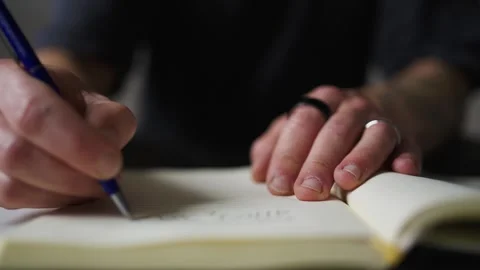 Man writing notes in notebook Stock Footage 341669419
