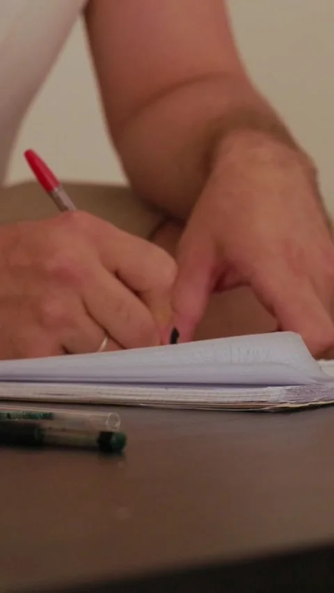 Man writing notes on notepad on a table Stock Footage 327862637