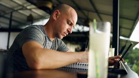 Man writing notes using digital tablet remote working Stock Photos
