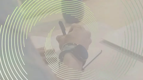 Man writing on paper at desk, concentric overlay appearing and initiating pen Stock Footage 334768691