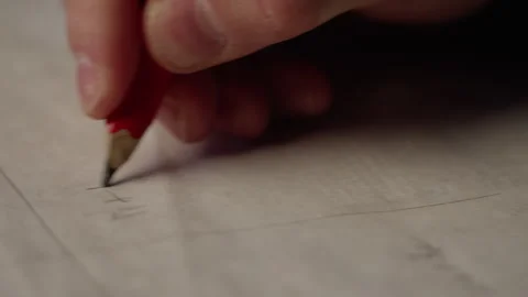 A man is writing on paper using a pencil Video stock 271546460