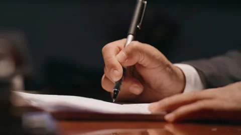 A man is writing with a pen Stock Footage 259676095