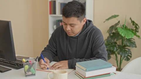 Man writing with pen, hand on notebook at desk in a building library study .. Stock Footage 337356116