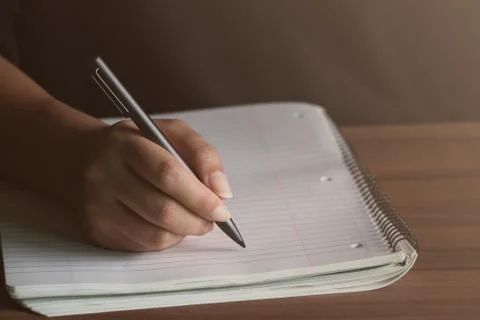 Man writing with a pen in Notebook diary In the concept of business office Stock Photos
