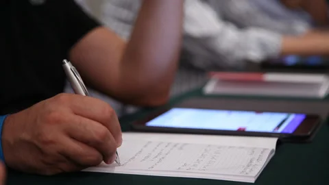 Man writing with a pen on a notebook Stock Footage 135014230