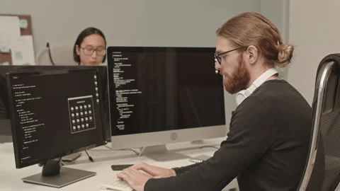 Man Writing Program Code on Computer Stock Footage 165723302