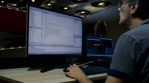 The man is writing a program. Programs run in virtual space. In the Stock Footage 218594607