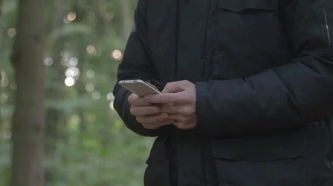 Man writing sms in forest Stock Footage 68583919
