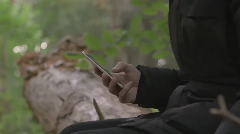 Man writing sms in forest Stock Footage 68583965