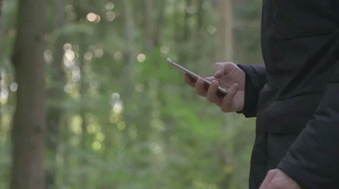 Man writing sms in forest Stock Footage 68583973