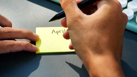 Man writing on sticky note with text April Fools' Day Stock Footage 269903659