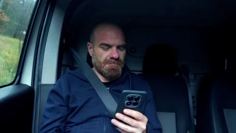 Man Writing Text Message on Smartphone in Car Passenger Seat Video stock 328643996