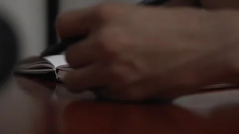 Man writing thoughts and ideas in a personal journal at home Video stock 320967439