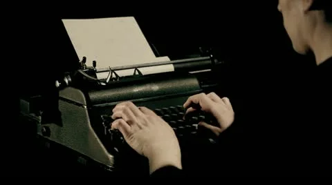 A man writing on a typewriter Stock Footage 27793047