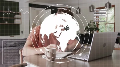 Man writing, typing at dining table, HUD globe overlay appearing and responding Stock Footage 333477855