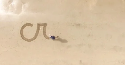 Man writing the word create in the sand Stock Footage 65511851