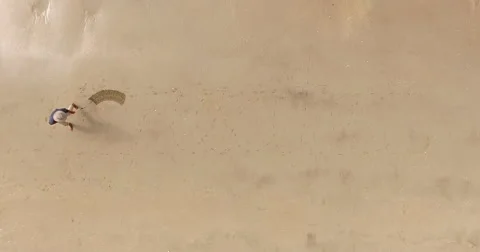 Man writing the word create in the sand Stock Footage 65530266