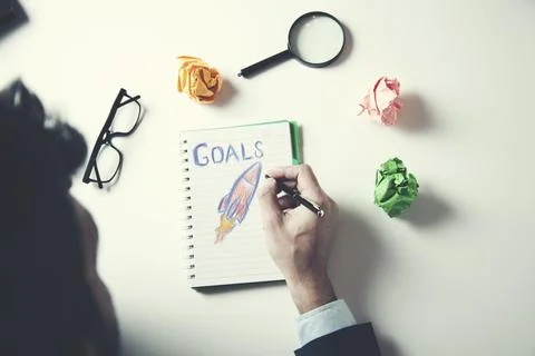 Man written goals text with racket on notepad Stock Photos