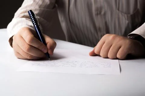 Man is  writting on a sheet of paper Foto stock