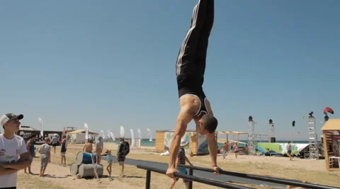 Man is Wrung Doing Handstand on The Parallel bars Video stock 59467883
