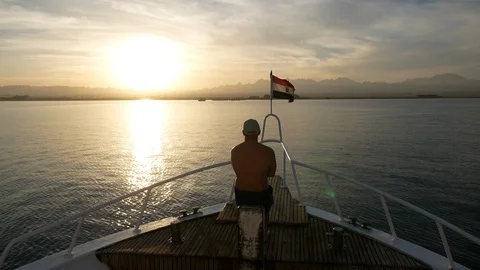 Man on a yacht on the sunset Stock Footage 89686836