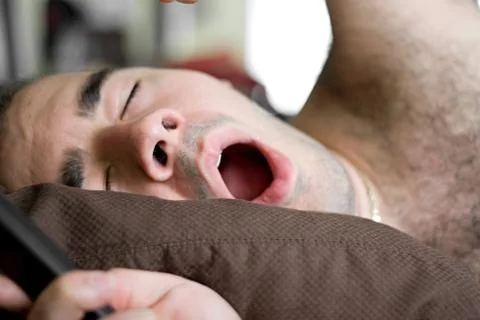 Man Yawning In Bed Stock Photos