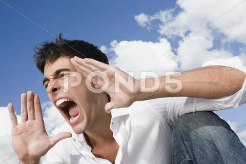 Man yelling with hands up Stock Photos