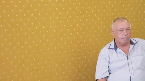 Man on a yellow background Stock Footage 76489686